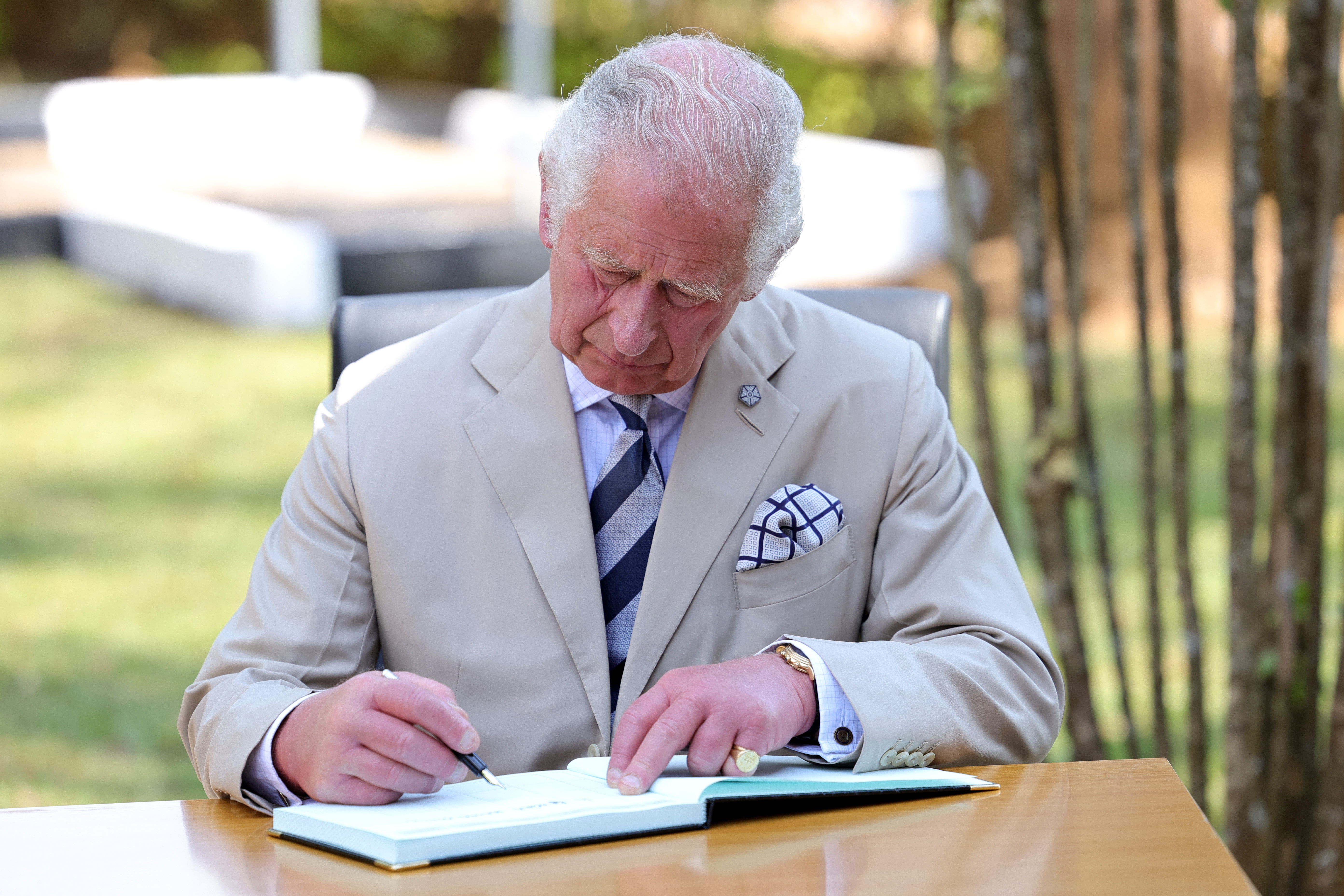 Prince of Wales signs visitors book at Nyamata Church Genocide Memorial