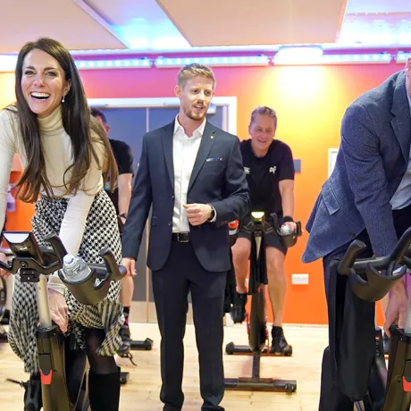 The Prince and Princess of Wales on exercise bikes