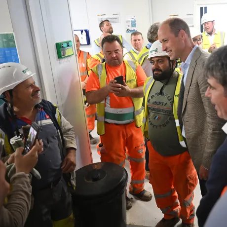 The Prince of Wales speaks with construction workers