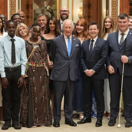 The King smiles alongside King's Trust ambassadors and Awards winners