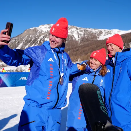 The Duke of Edinburgh smiles for a photo with Team GB athletes Charlotte Bankes and Huw Nightingale