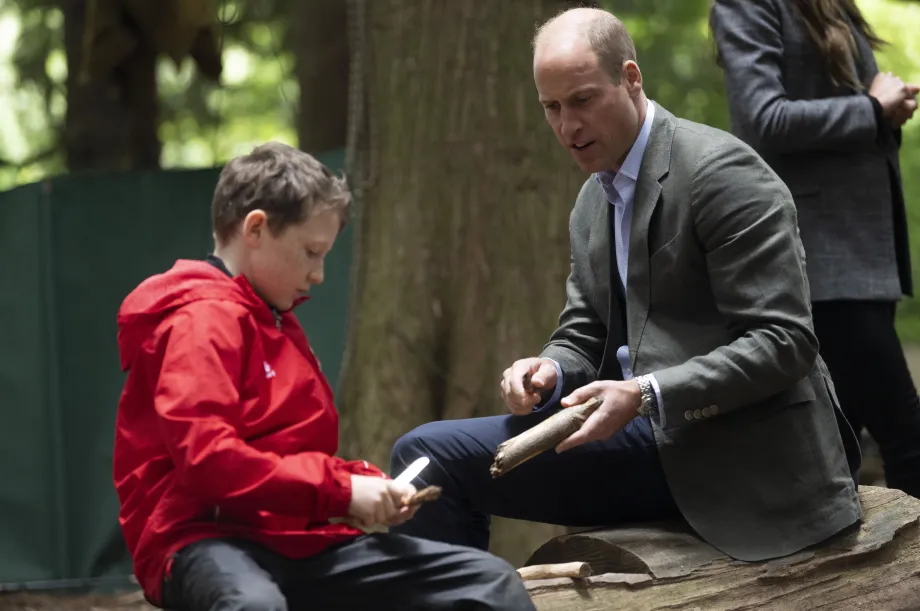 The Prince if Wales whittling with a young boy