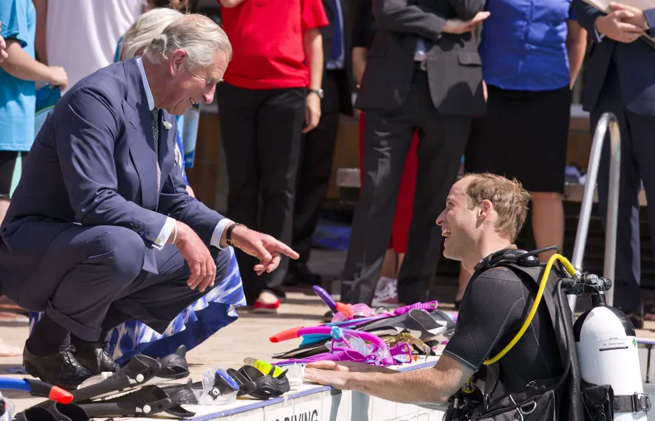 The King speaks to The Prince of Wales as he scuba dives 