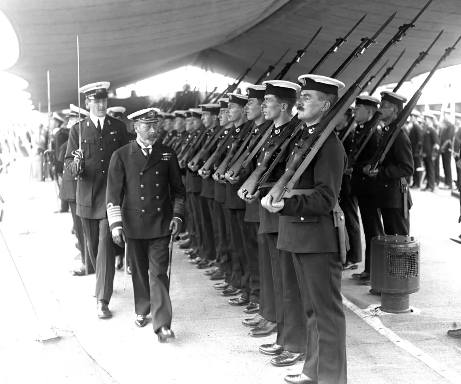 King George V inspects Marines on HMS Renown. 