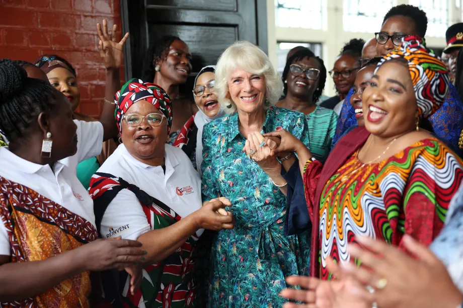 Queen Camilla dances with volunteers and staff from Sauti Ya Wanawake (the voice of women)during a visit to the Situation Room in Mombasa County, Kenya.
