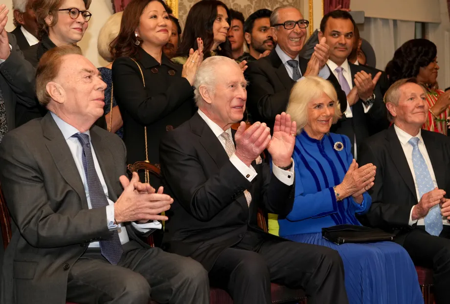 The King and Queen applauding a performance at a Commonwealth Reception