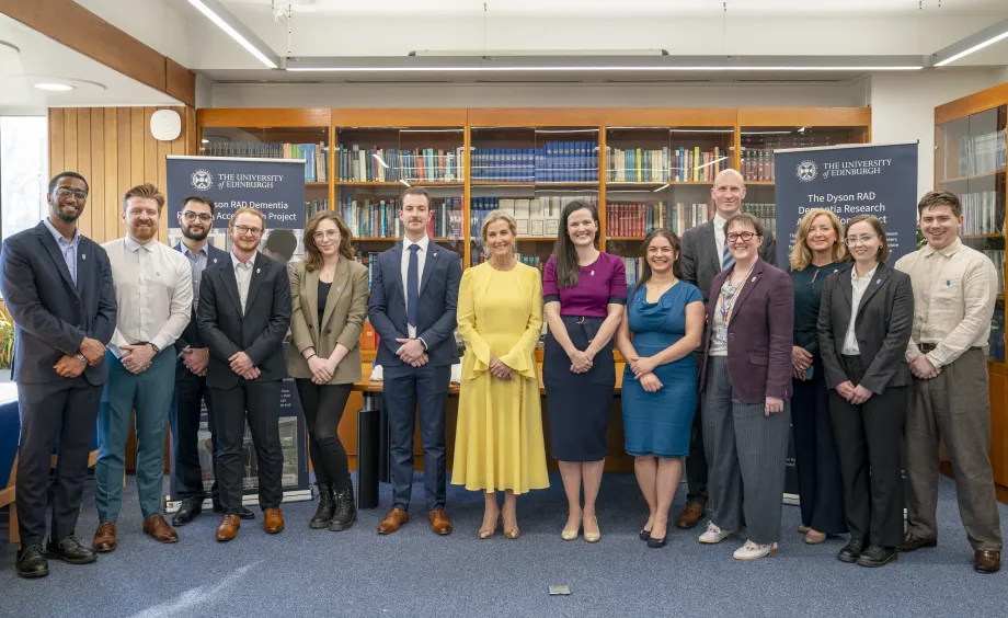 The Duchess of Edinburgh smiling for a group photo at Edinburgh Neuroscience