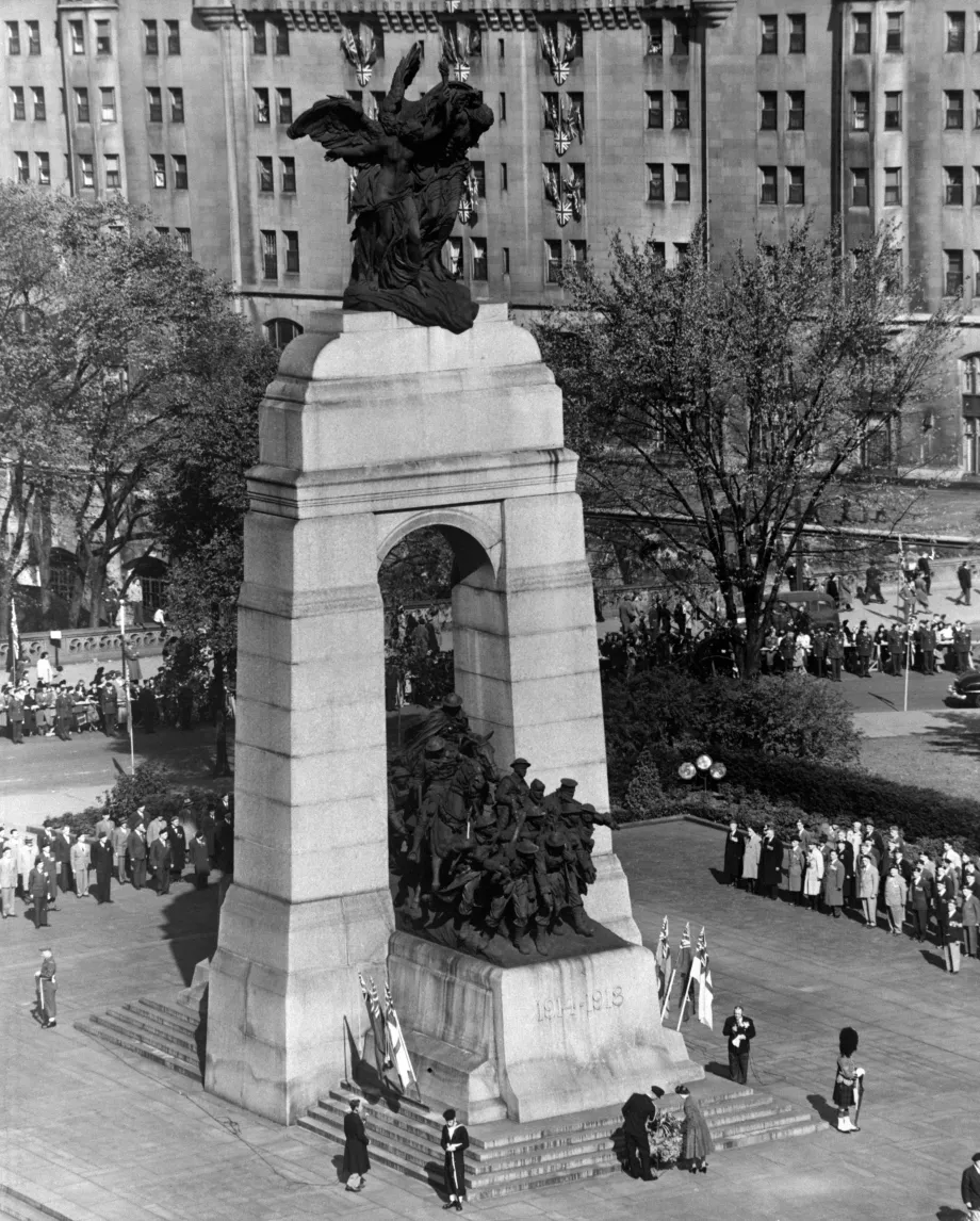 Princess Elizabeth and the Duke of Edinburgh place a wreath at the foot of the National War Memorial in Ottawa, Canada