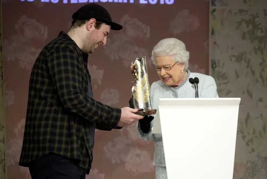 Queen Elizabeth II presents Richard Quinn with the inaugural Queen Elizabeth II Award for British Design