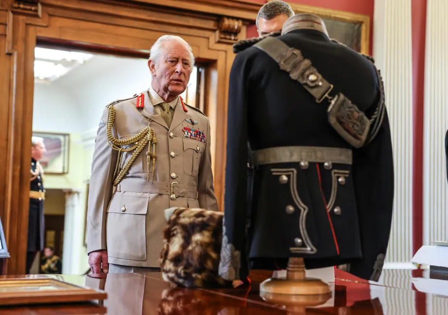 The King views the artillery uniform of his ancestor King George V