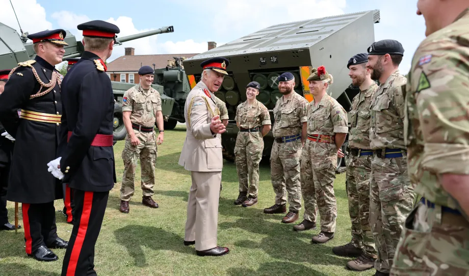 The King speaks to soldiers next to the multiple launch rocket system (MLRS)