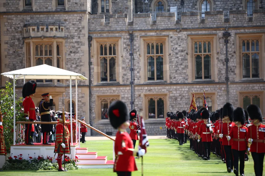 His Majesty salutes the Coldstream Guards as they march off parade after a ceremony at Windsor Castle