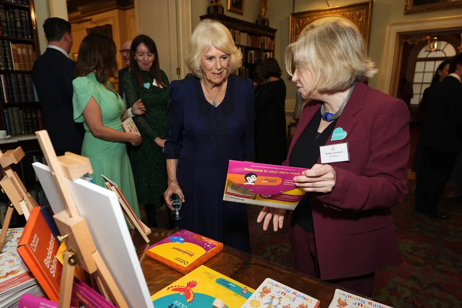 The Queen views a book during a reception to celebrate the centenary of BookTrust
