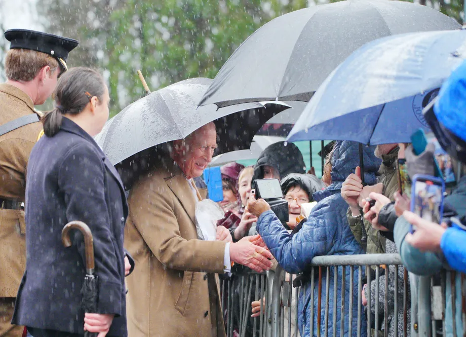 The King shakes hands with members of the public outside Cyfarthfa Castle