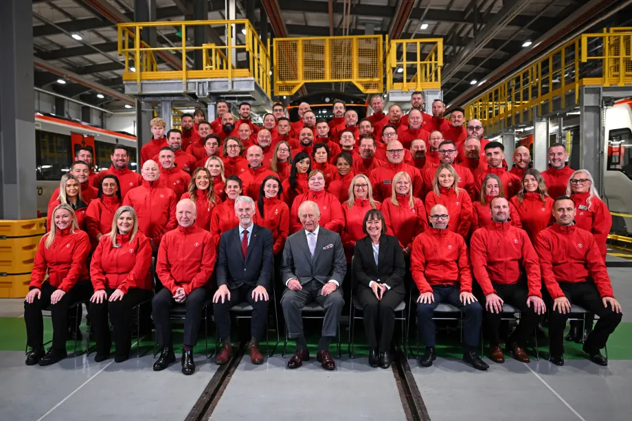 The King smiles alongside staff at the South Wales Metro Depot