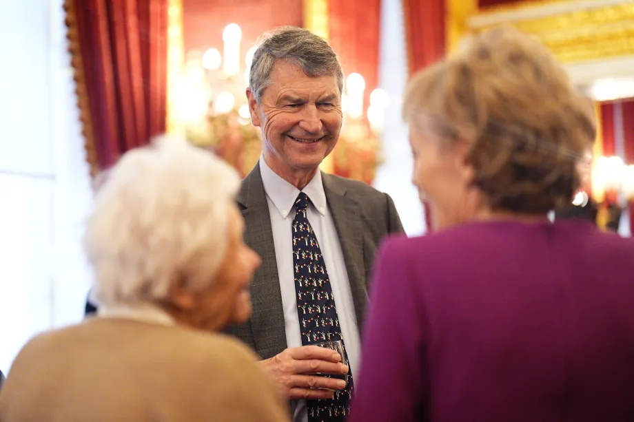 Sir Tim Laurence chats with guests during the Christmas tea party