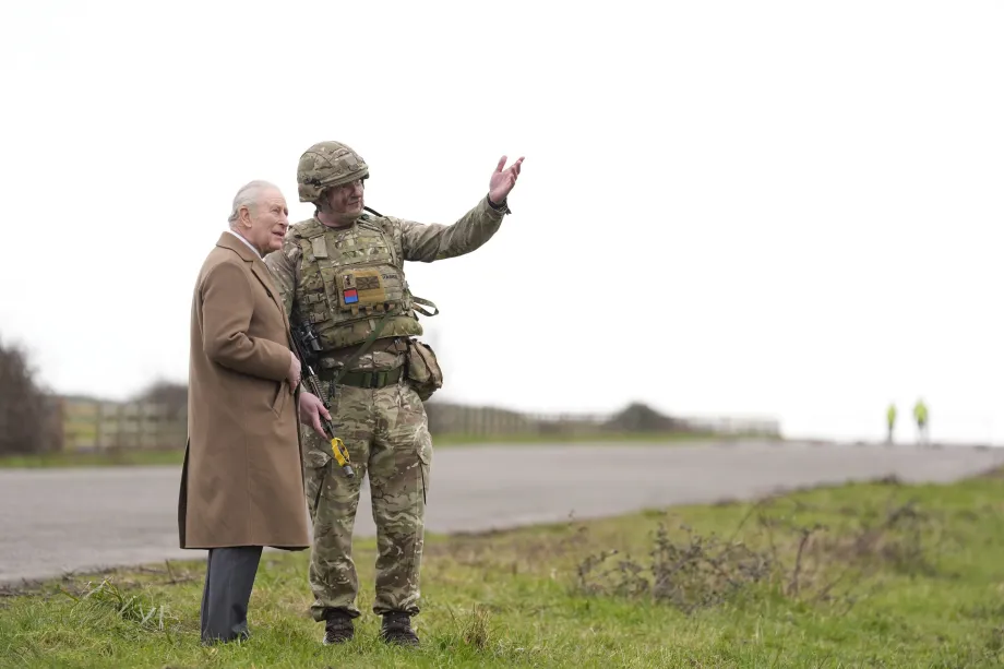 The King talks to a member of staff during a visit to Thorney Island