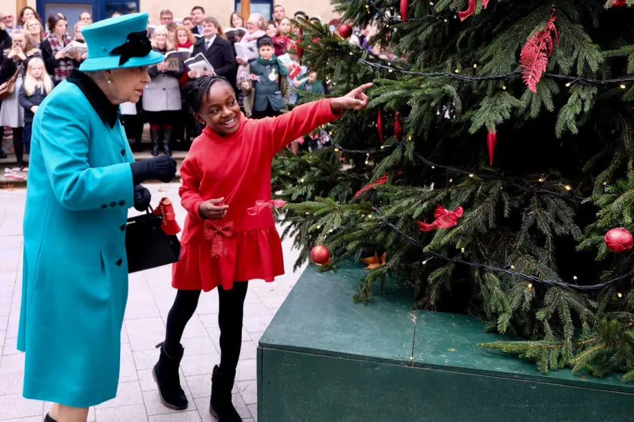 The Queen helps decorate the Coram Christmas tree at the opening of the Queen Elizabeth II Centre 
