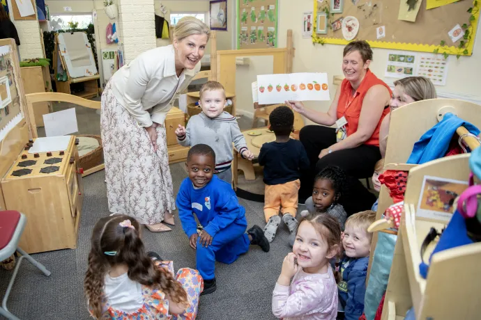 The Duchess of Edinburgh smiles with a group of nursery children