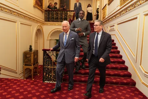 The King walks with Prime Minister Sir Keir Starmer, followed by Idris Elba in St James's Palace
